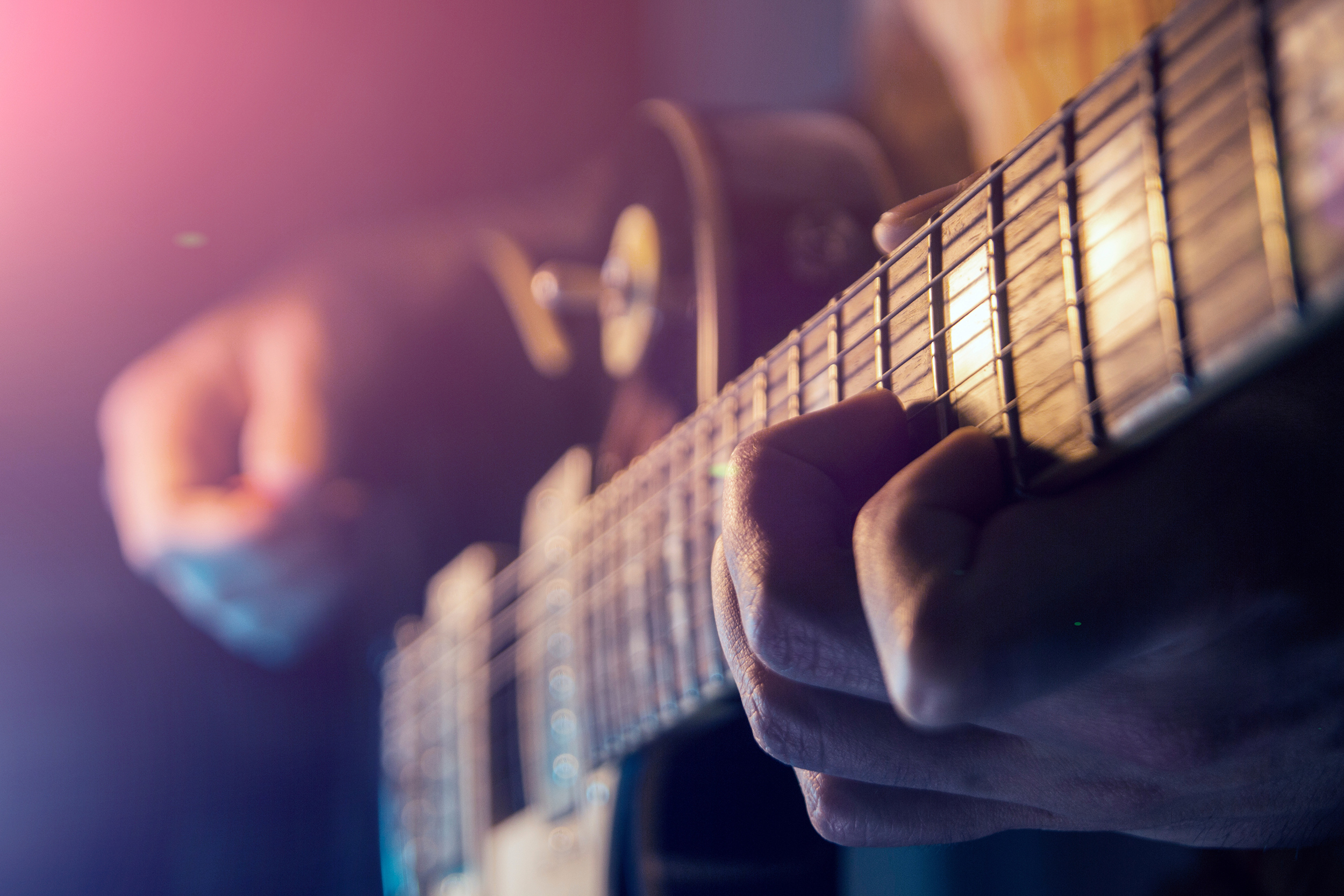 Close up of a guitarist playing guitar.